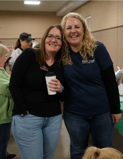Two staff smiling